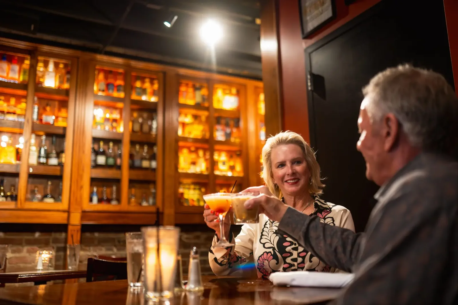 Guests sharing a drink at the bar in Spirits
