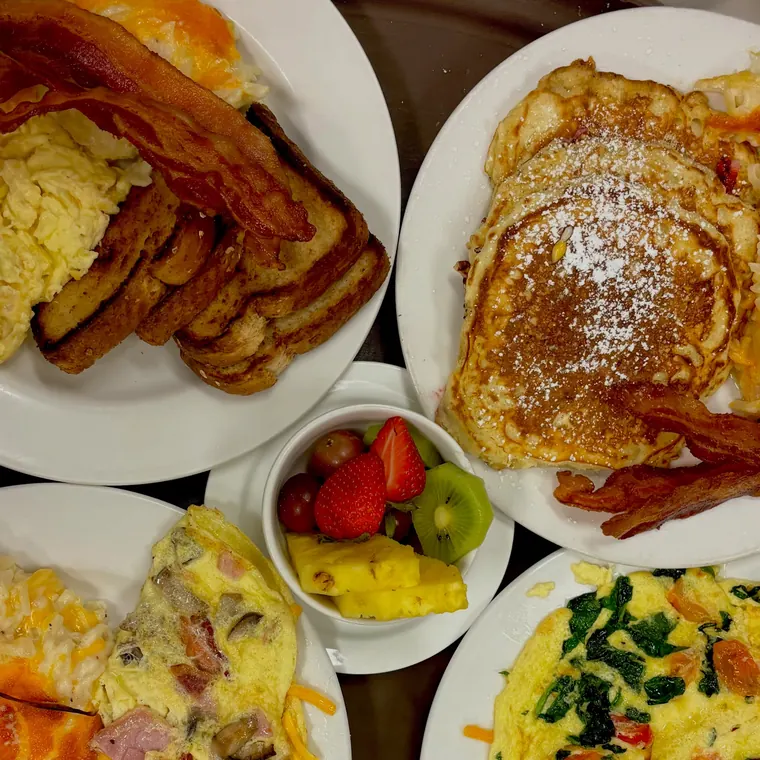 Sunday brunch: pancakes, bacon, an omelet and fresh fruit